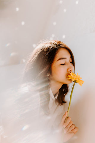 woman smelling flower