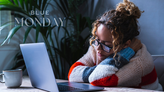 woman sitting sad on her laptop for blue monday