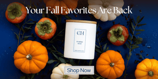 Candle with pumpkins and fall decorations on a blue background